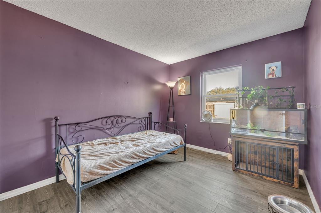 222 West Panama Road Winter Springs, FL 32708 - Photo 13 of 25 a bedroom with a bed and wooden floor