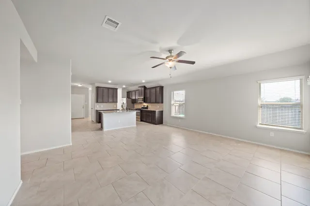 a view of a livingroom with furniture and chandelier fan