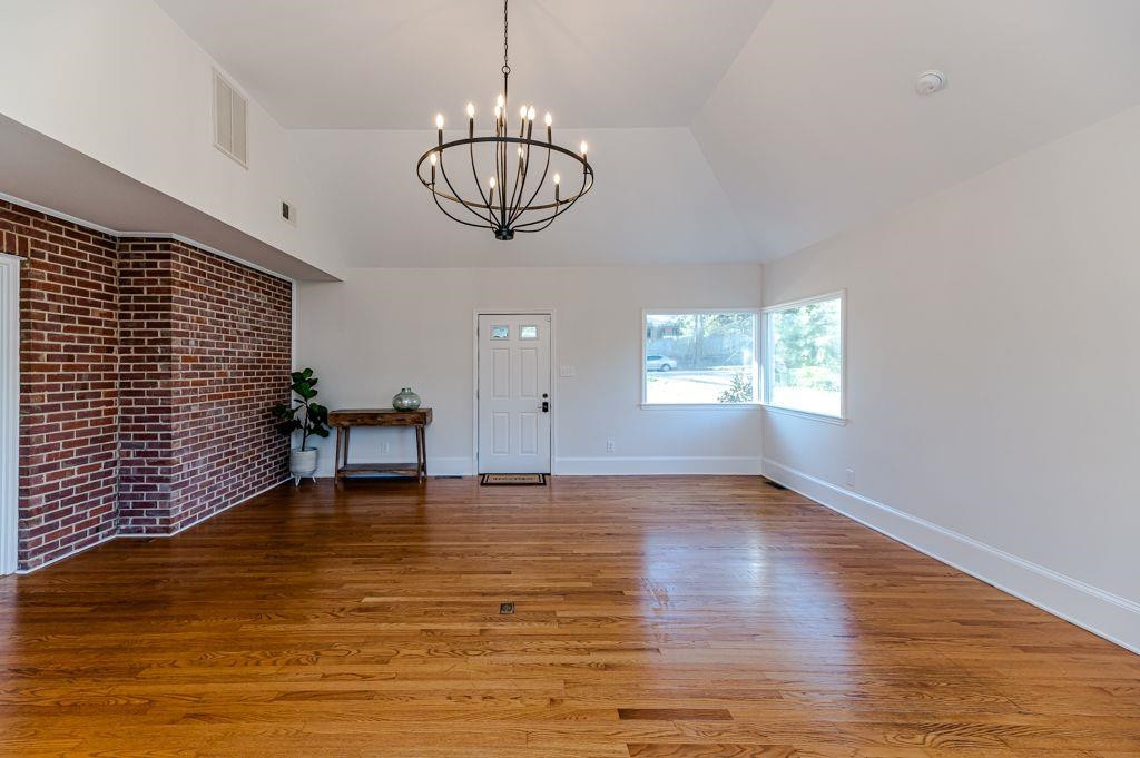 2618 Wade Avenue Raleigh, NC 27607 - Photo 16 of 62 a view of an empty room with window and wooden floor