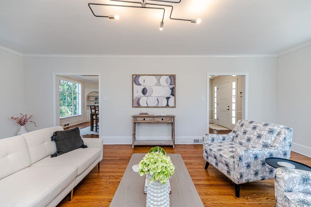 2618 Wade Avenue Raleigh, NC 27607 - Photo 18 of 62 a living room with furniture and painting on the wall