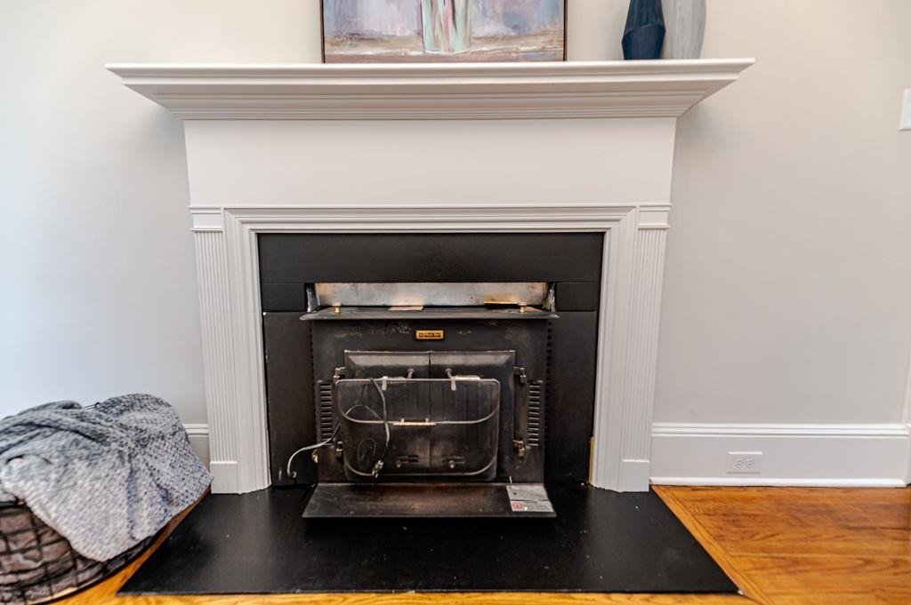 2618 Wade Avenue Raleigh, NC 27607 - Photo 20 of 62 a room with a fireplace and a potted plant