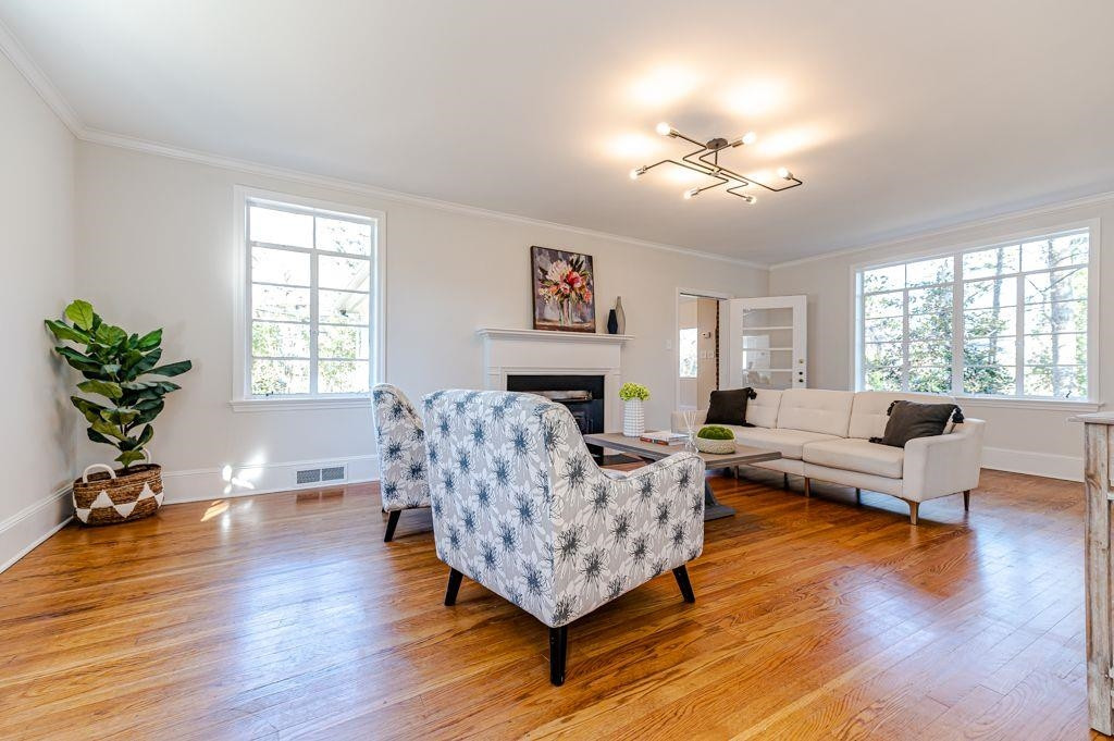 2618 Wade Avenue Raleigh, NC 27607 - Photo 23 of 62 a living room with furniture large window and wooden floor