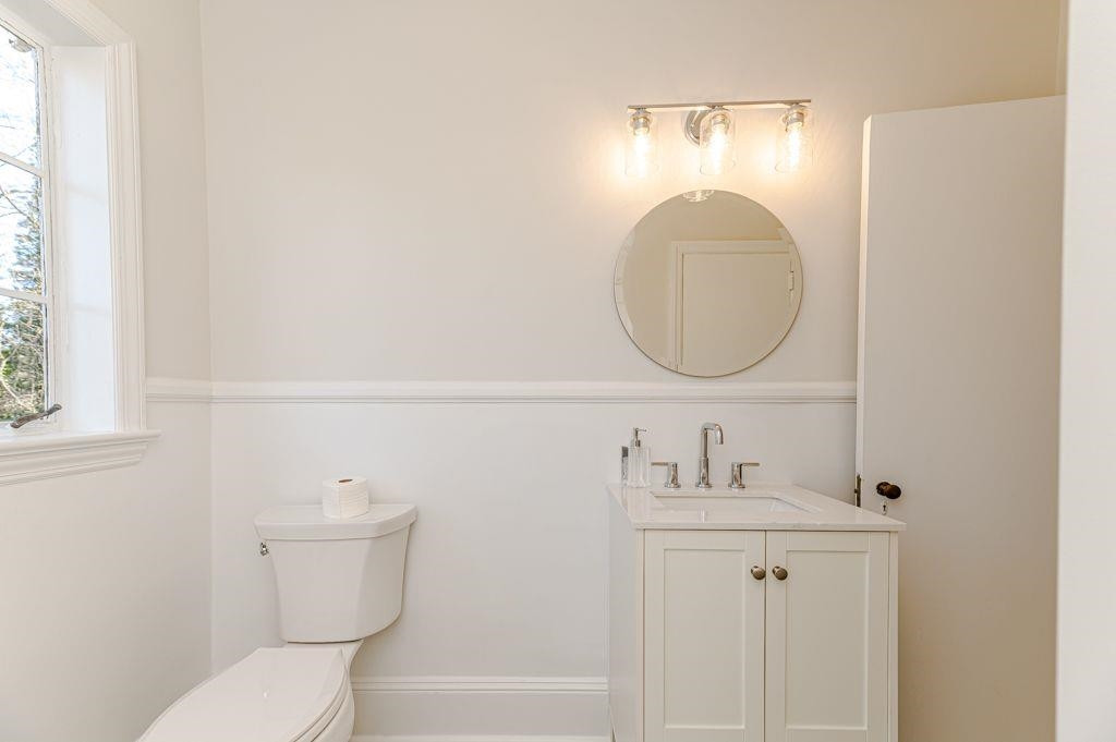 2618 Wade Avenue Raleigh, NC 27607 - Photo 34 of 62 a bathroom with a toilet a sink and mirror