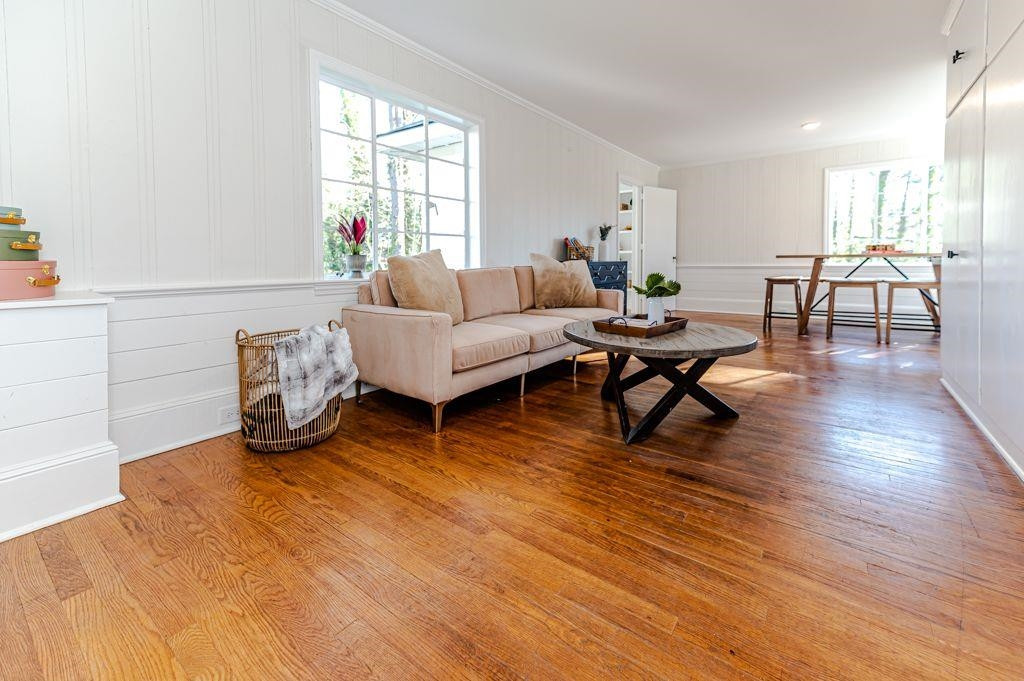 2618 Wade Avenue Raleigh, NC 27607 - Photo 35 of 62 a living room with furniture and a wooden floor