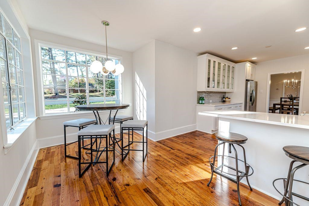 2618 Wade Avenue Raleigh, NC 27607 - Photo 41 of 62 a kitchen with stainless steel appliances kitchen island hardwood floor and a table chair