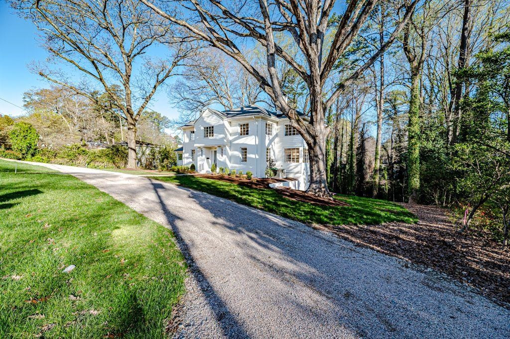 2618 Wade Avenue Raleigh, NC 27607 - Photo 54 of 62 a pathway of a house with a yard and large trees