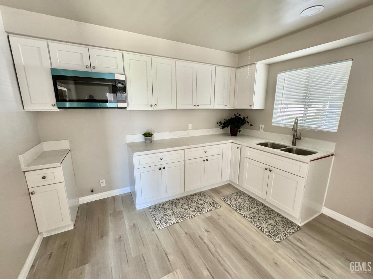 Undisclosed Address Delano, CA 93215 - Photo 4 of 11 a kitchen with white cabinets a sink stove and refrigerator