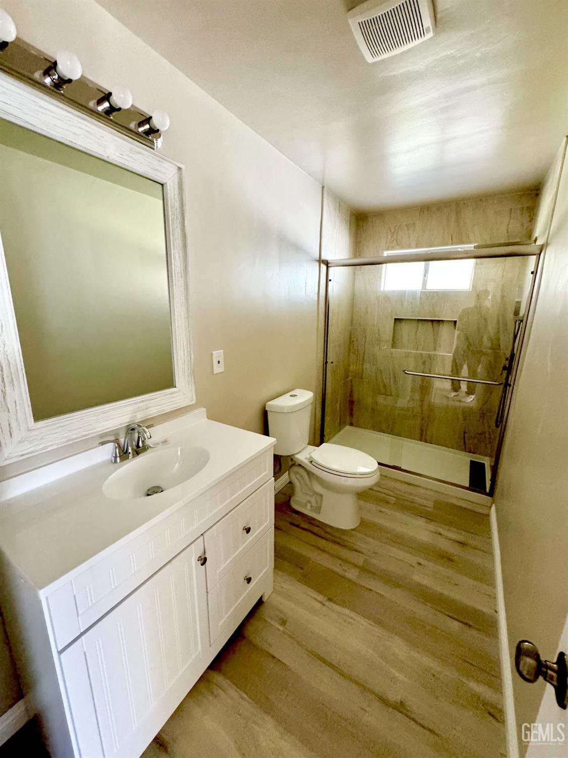 Undisclosed Address Delano, CA 93215 - Photo 7 of 11 a bathroom with a double vanity sink toilet and shower