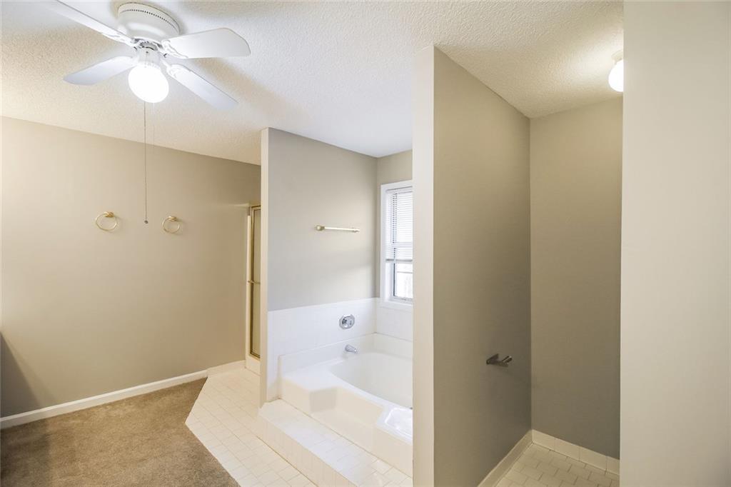 4358 Wesleyan Pointe Decatur, GA 30034 - Photo 6 of 30 a bathroom with a bathtub and a shower
