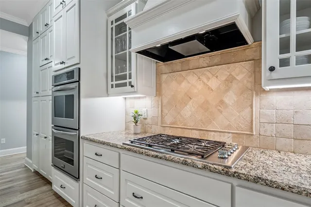 a stove top oven sitting inside of a kitchen