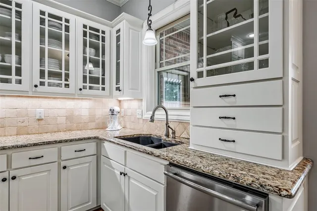 a kitchen with a sink and cabinets