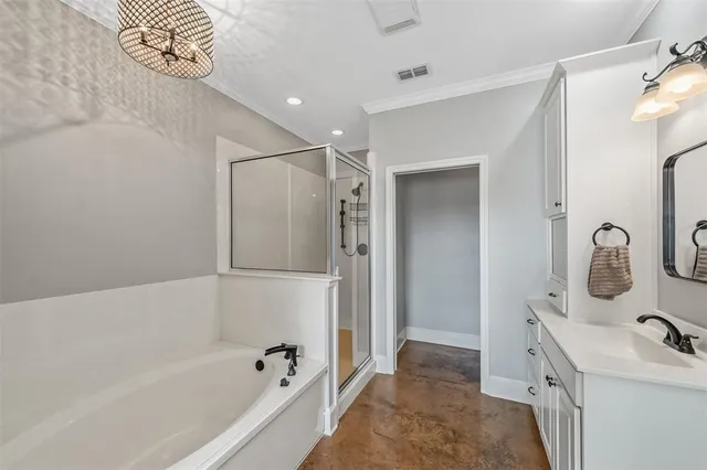 a bathroom with a bathtub sink vanity and mirror