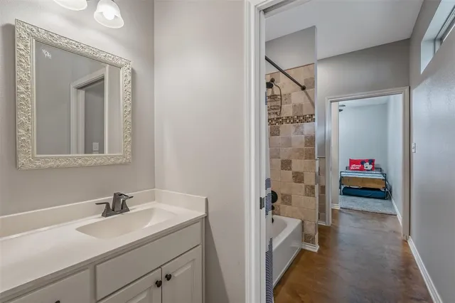 a en suite bathroom with a sink and a mirror