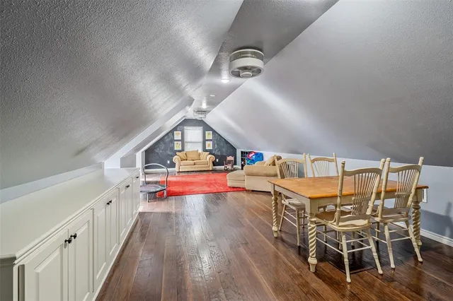 a dining room with furniture a chandelier and wooden floor