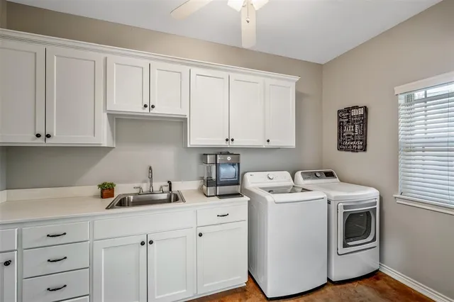 a kitchen with white cabinets and white appliances