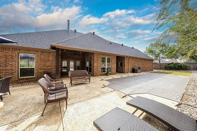 a view of house with yard and sitting area