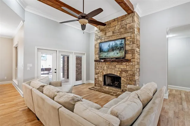 a living room with furniture a flat screen tv and a fireplace