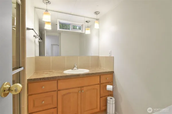 a bathroom with a sink vanity and a mirror