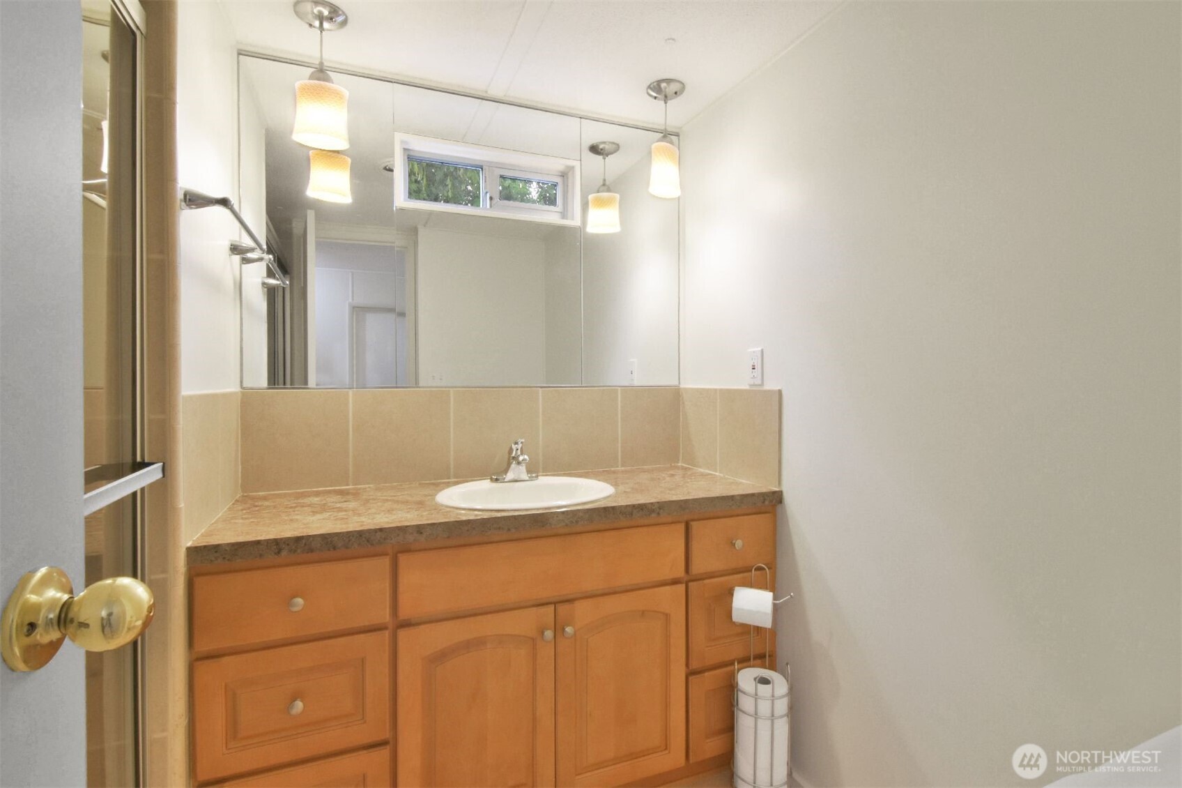 13320 Highway 99, Unit 54 Everett, WA 98204 - Photo 14 of 16 a bathroom with a sink vanity and a mirror