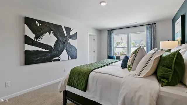 a bedroom with a bed and a painting on the wall