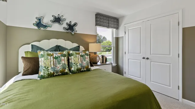 a bedroom with bed and window