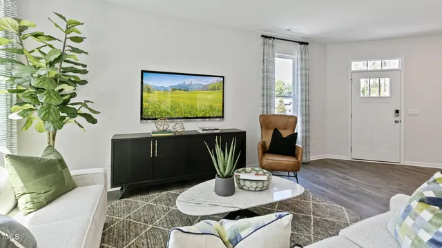 a living room with furniture potted plant and a window