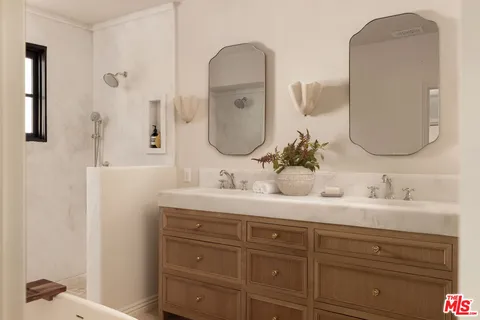 a bathroom with a double vanity sink and a mirror