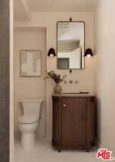 a bathroom with a sink vanity and a toilet