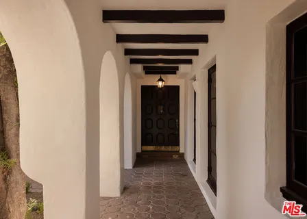 a view of a hallway with wooden shelves
