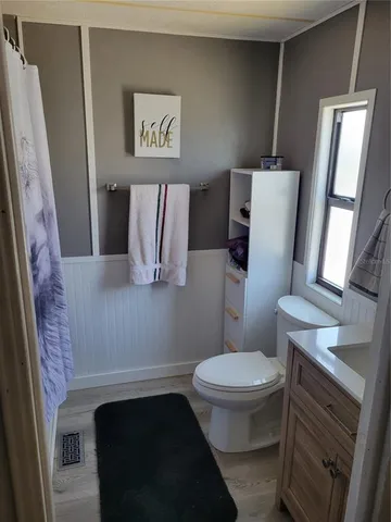 a bathroom with a toilet and a mirror
