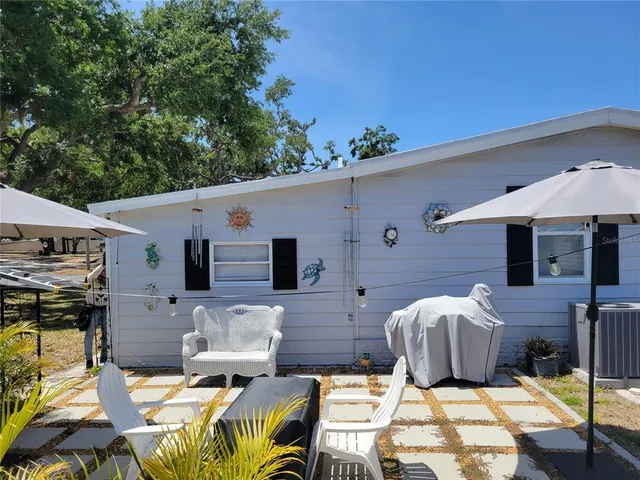 a view of a patio with table and chairs with wooden floor and fence