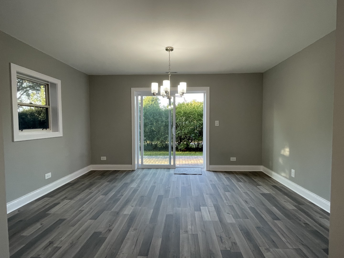 5547 South Peck Avenue Countryside, IL 60525 - Photo 6 of 26 a view of an empty room with wooden floor and a window