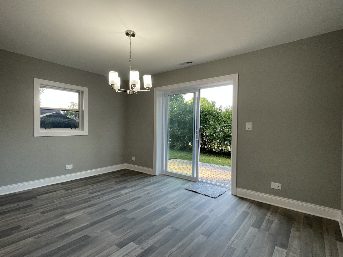 5547 South Peck Avenue Countryside, IL 60525 - Photo 7 of 26 an empty room with wooden floor and windows