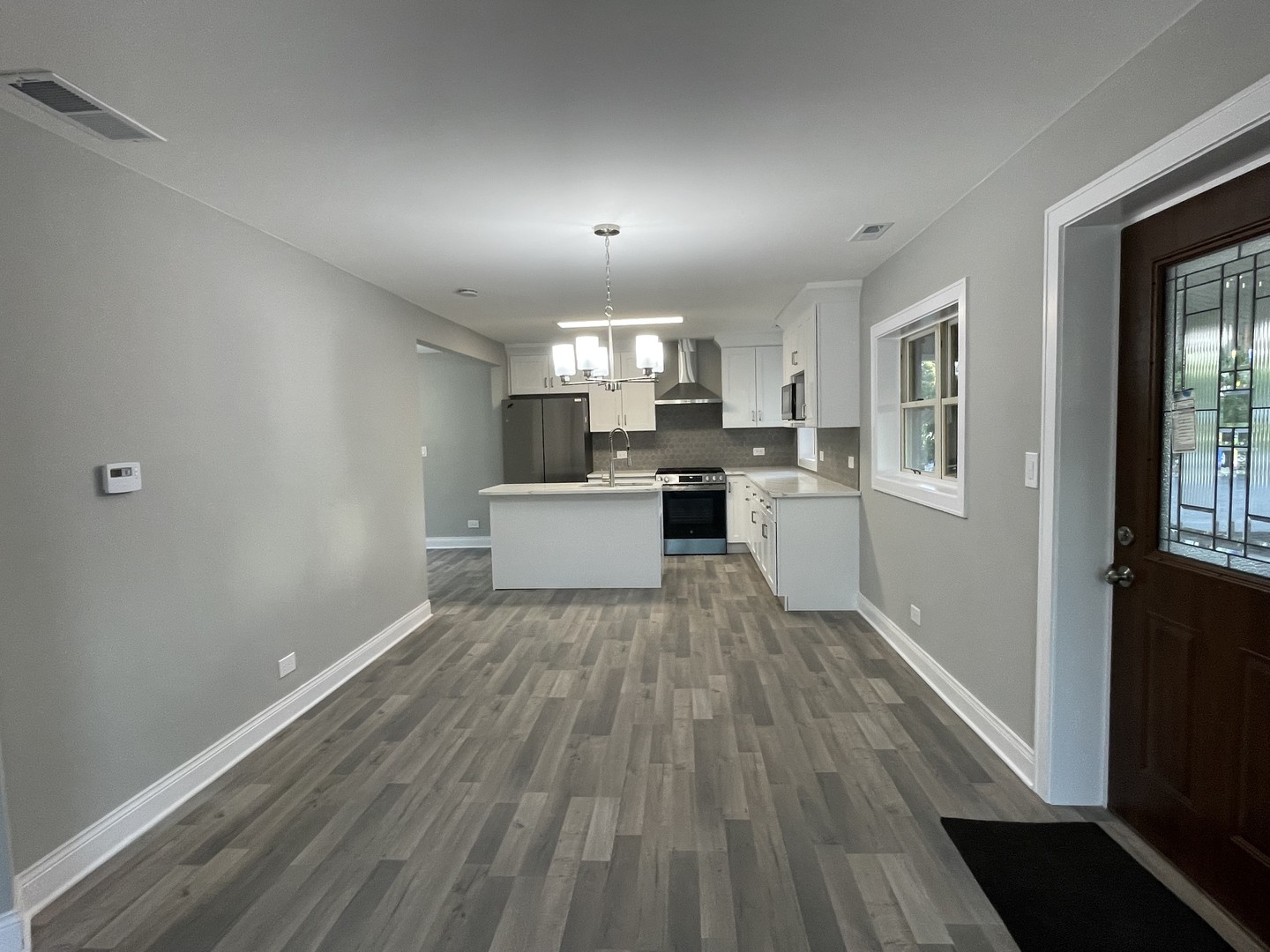 5547 South Peck Avenue Countryside, IL 60525 - Photo 8 of 26 a view of a kitchen with wooden floor and electronic appliances