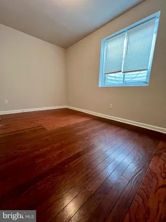 a view of a room with wooden floor and window