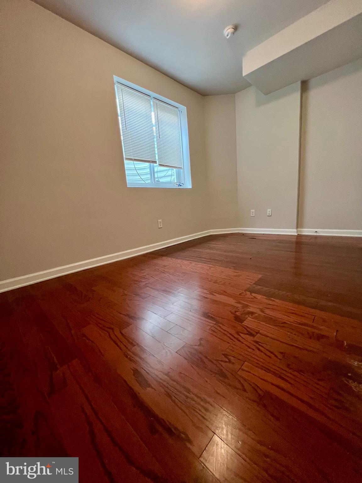2106 North 17th Street, Unit 2 Philadelphia, PA 19121 - Photo 15 of 31 an empty room with wooden floor and windows