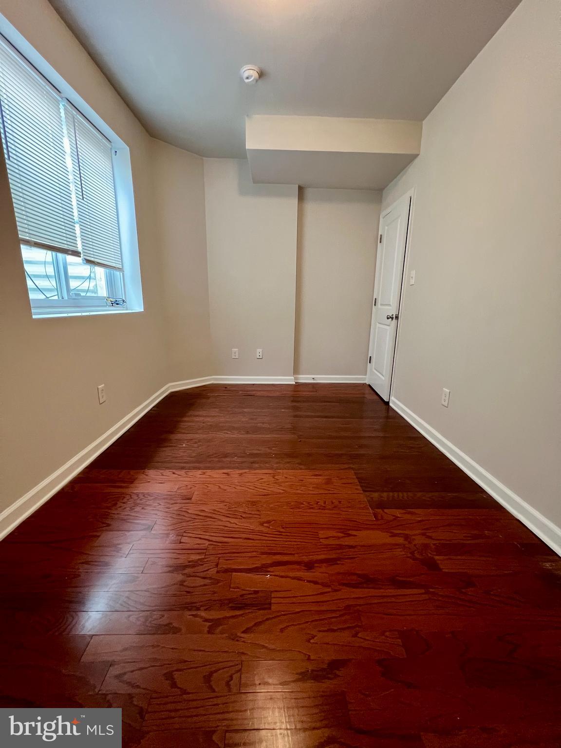 2106 North 17th Street, Unit 2 Philadelphia, PA 19121 - Photo 16 of 31 a view of an empty room with wooden floor and a window