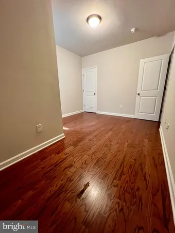 an empty room with wooden floor