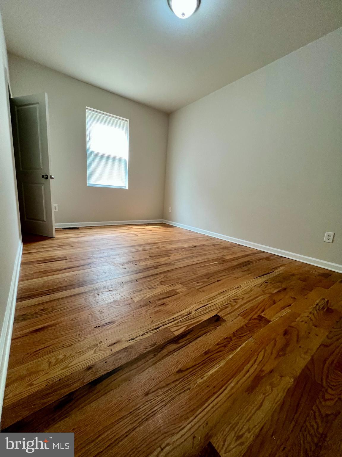 2106 North 17th Street, Unit 2 Philadelphia, PA 19121 - Photo 22 of 31 a view of empty room with window and wooden floor