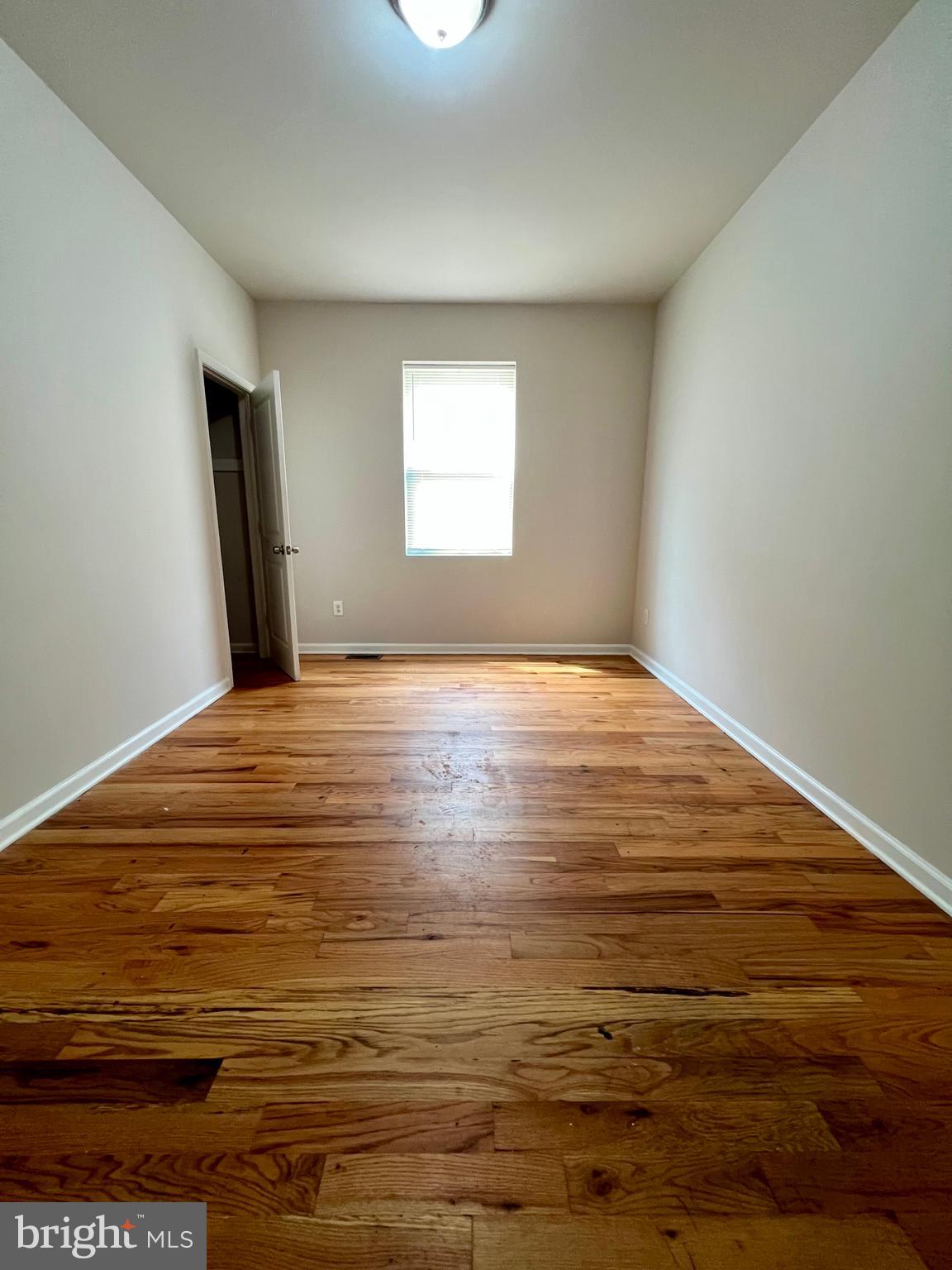 2106 North 17th Street, Unit 2 Philadelphia, PA 19121 - Photo 27 of 31 a view of an empty room with wooden floor and a window