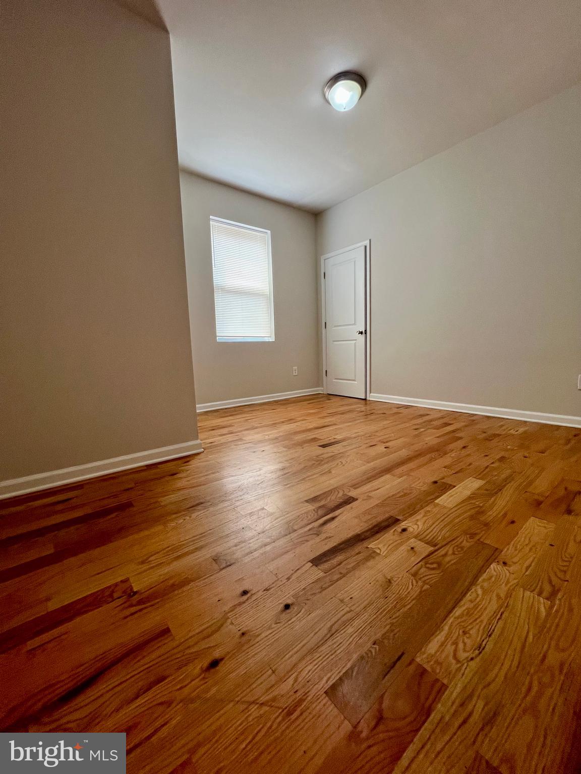 2106 North 17th Street, Unit 2 Philadelphia, PA 19121 - Photo 30 of 31 a view of an empty room with window and wooden floor