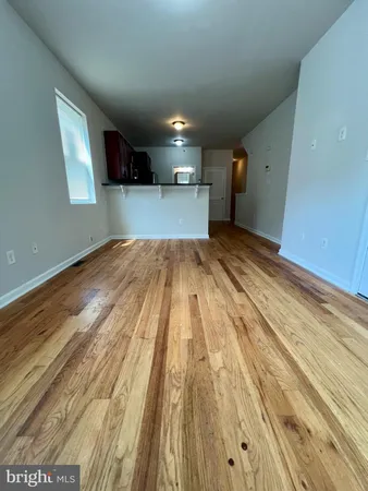a view of a room with wooden floor