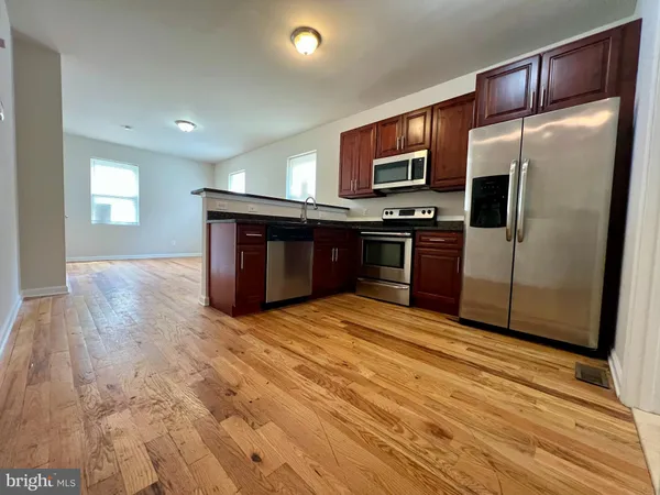 a kitchen with stainless steel appliances granite countertop a refrigerator stove and oven