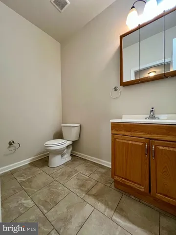 a bathroom with a sink a toilet and mirror