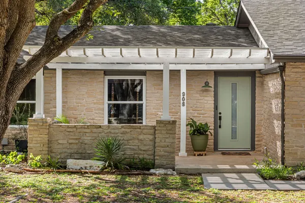 a living room with furniture a fireplace and a potted plant