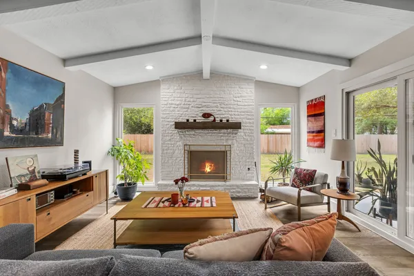 a living room with furniture a rug and a large window