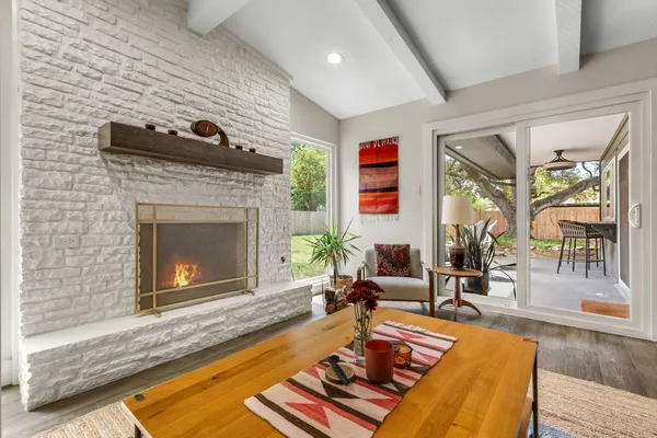a kitchen with kitchen island granite countertop a sink a counter top space stainless steel appliances and a window
