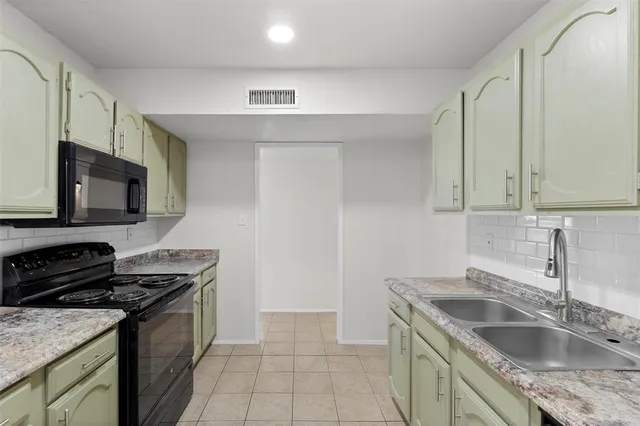 a kitchen that has a sink and a stove