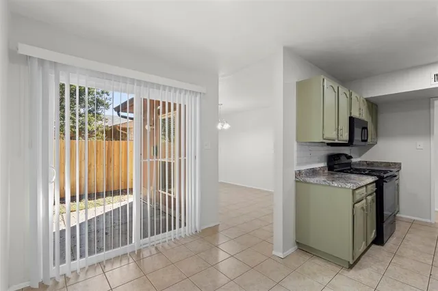 a kitchen with a stove top oven and cabinets