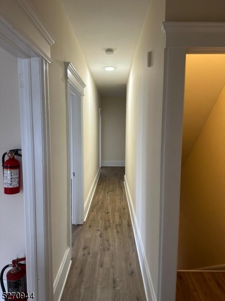 34 Richards Avenue, Unit B Dover, NJ 07801 - Photo 8 of 9 a view of a hallway with wooden floor and a bathroom